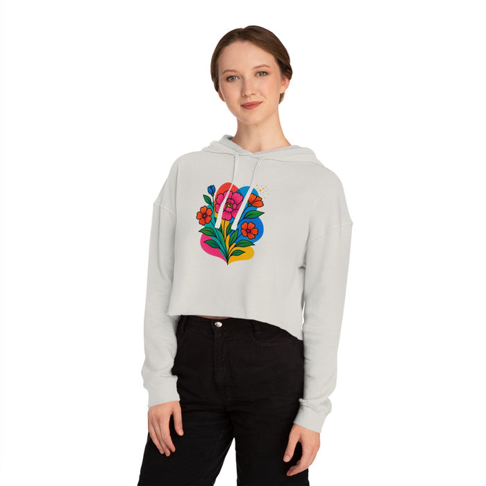 Person wearing a light gray hoodie with a colorful floral design on a white background