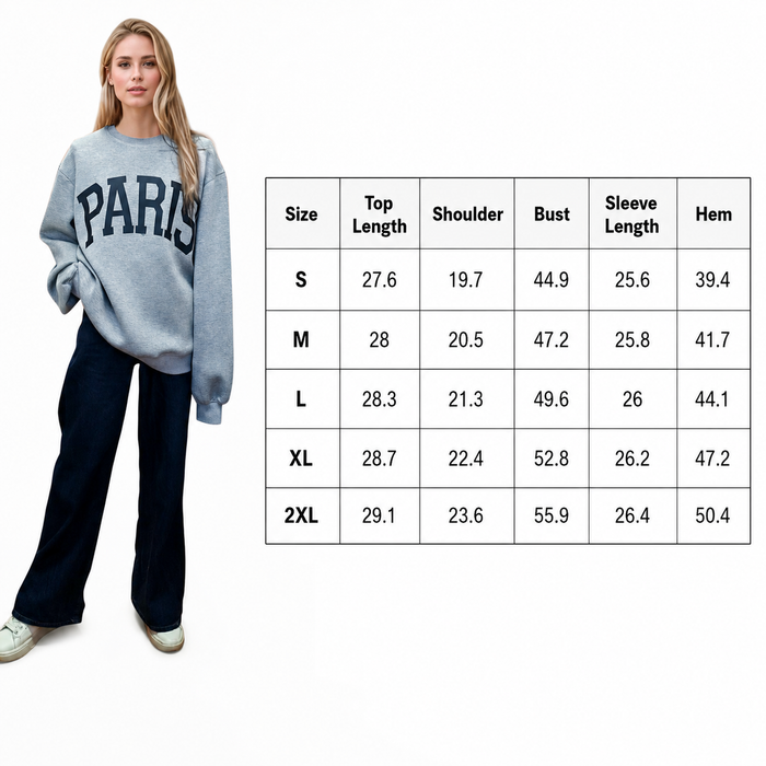 A woman modeling a light blue sweatshirt with 'PARIS' printed across the chest, shown next to a size chart table listing measurements from S to 2XL.
