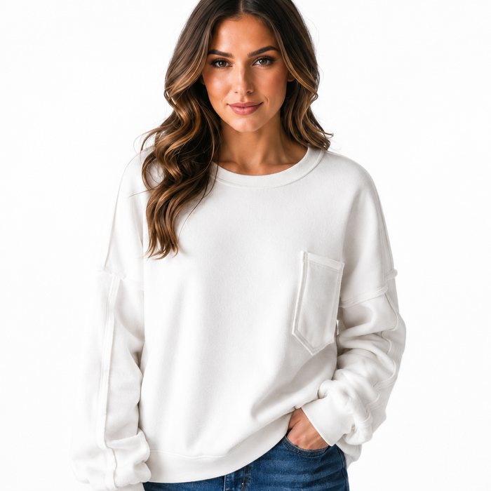 White women's shirt with pockets shown in a polished everyday outfit, exposed seams and easy relaxed silhouette for work use.