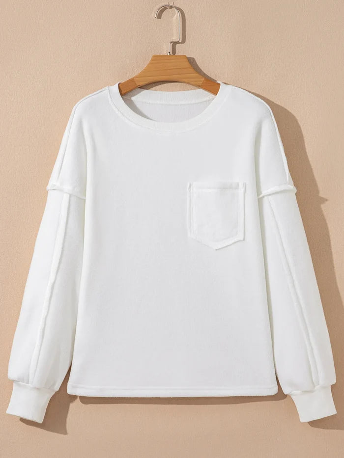 exposed seam top women neutral color outfit paired with denim jeans casual chic style